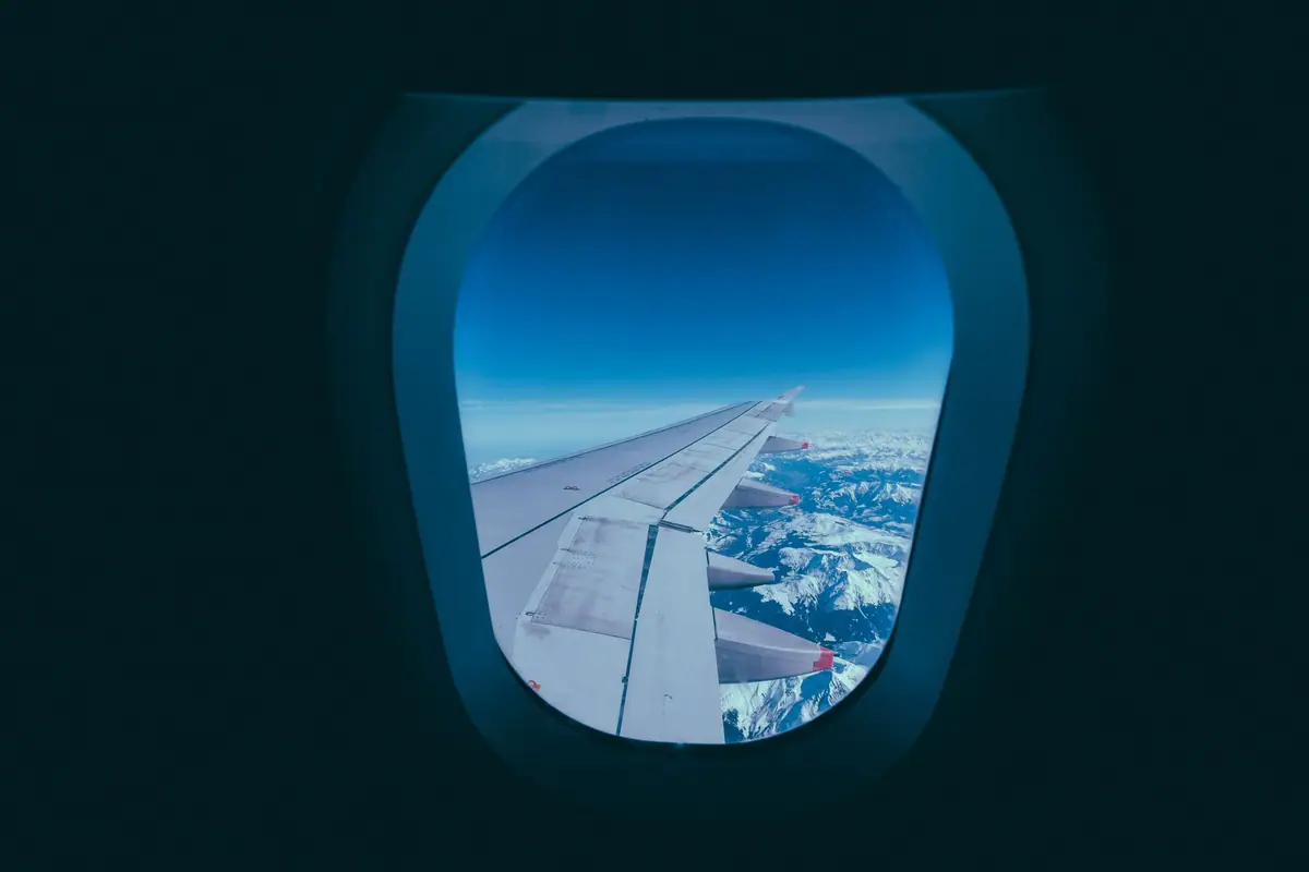An airplane wing seen through the cabin window