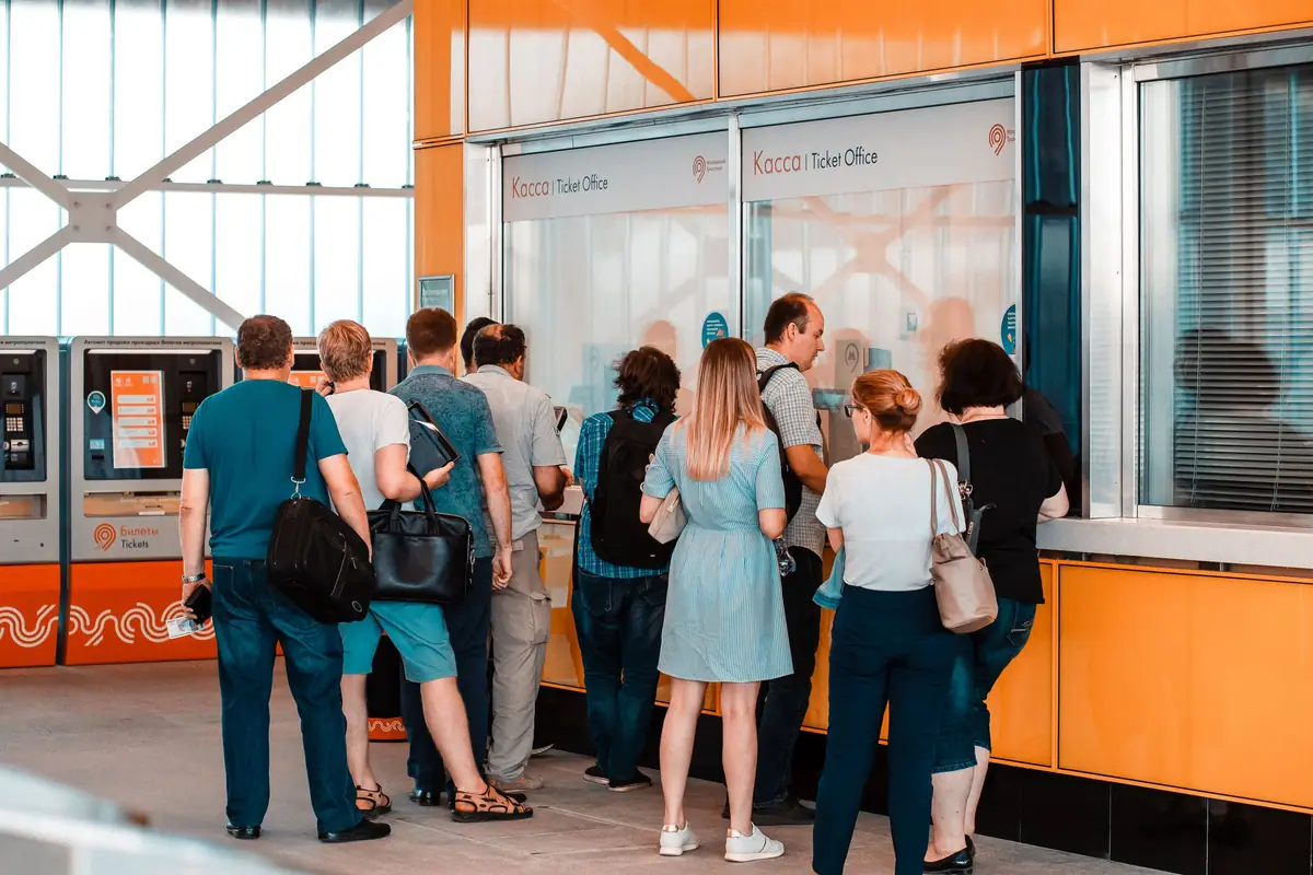 People waiting in line at a service counter